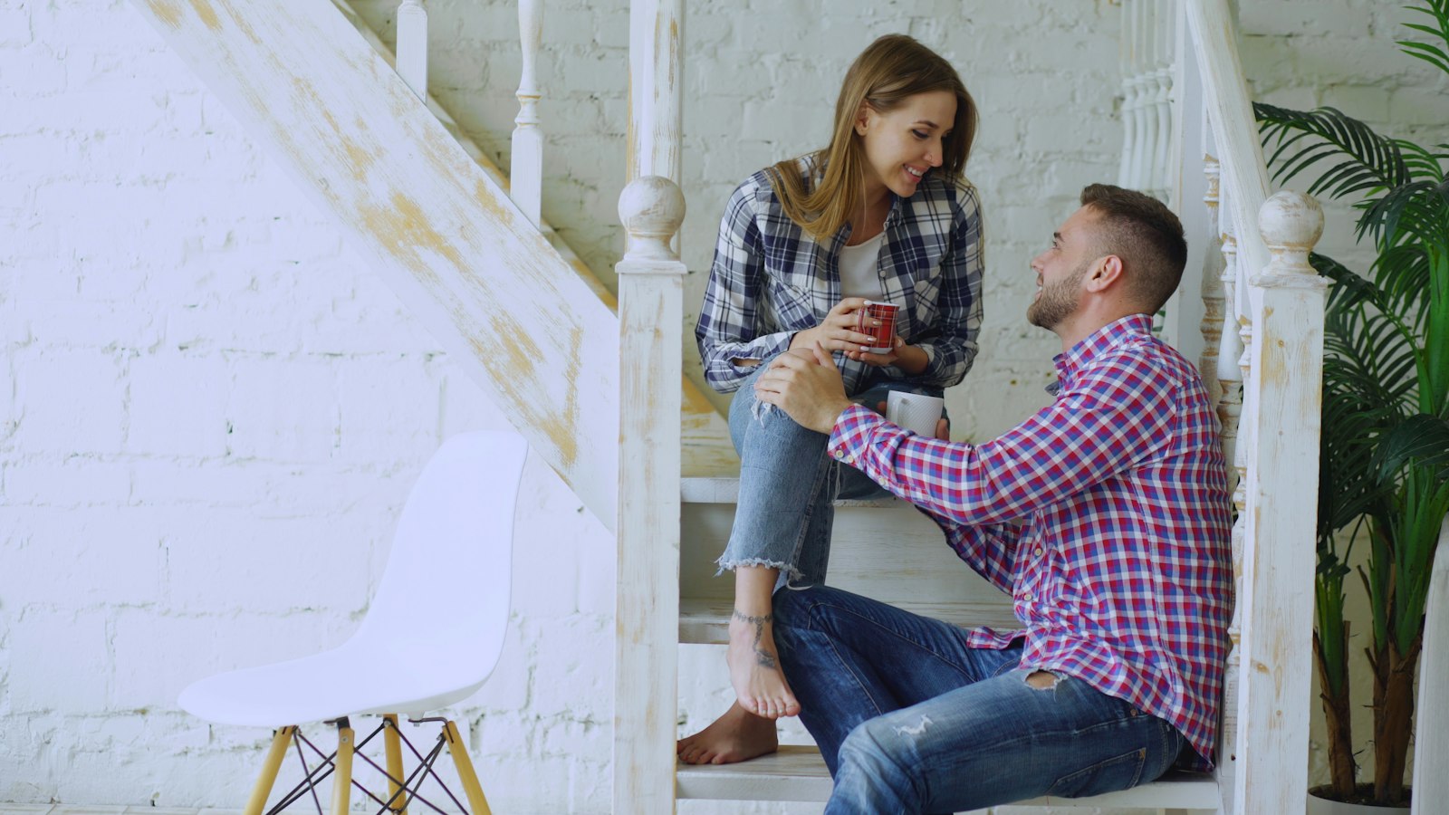 A couple talking closely at home with warmth and emotional openness