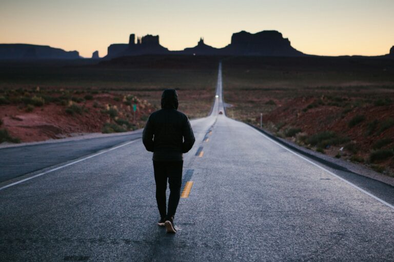A person walking toward the sunset, symbolizing growth and transformation